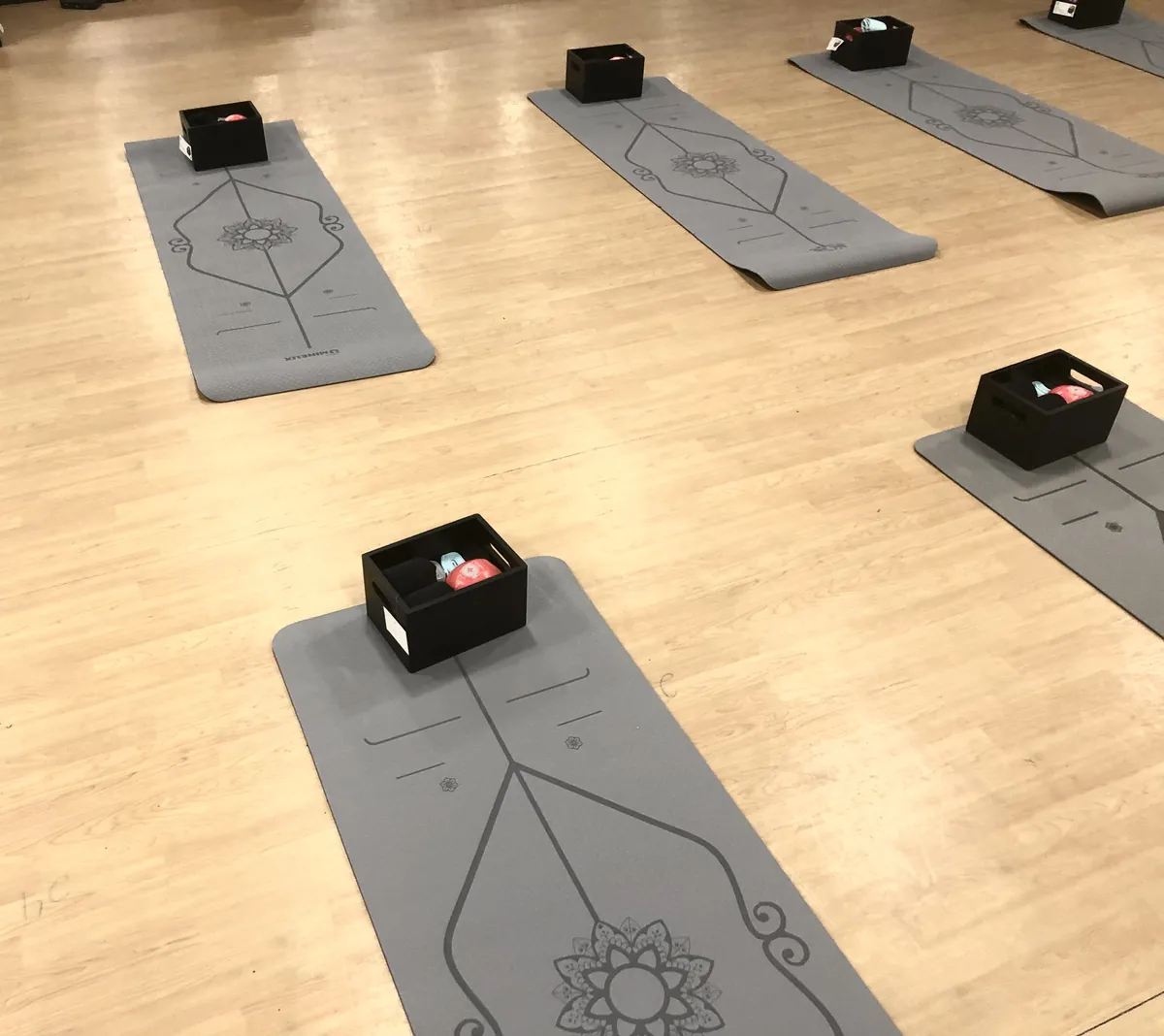 Exercise mat laid out with kit boxes for a mat-based class