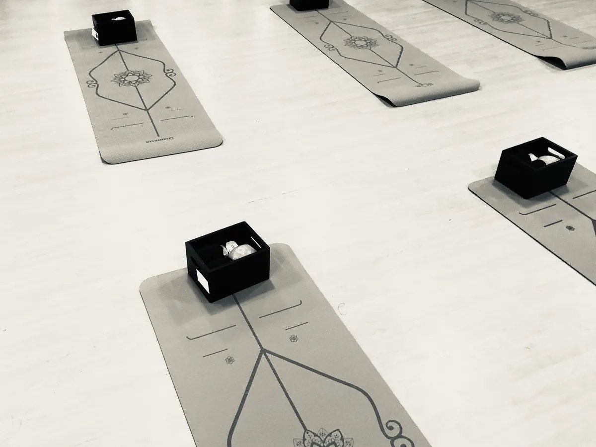 Rows of mats with prop boxes set up for an advanced flexibility class